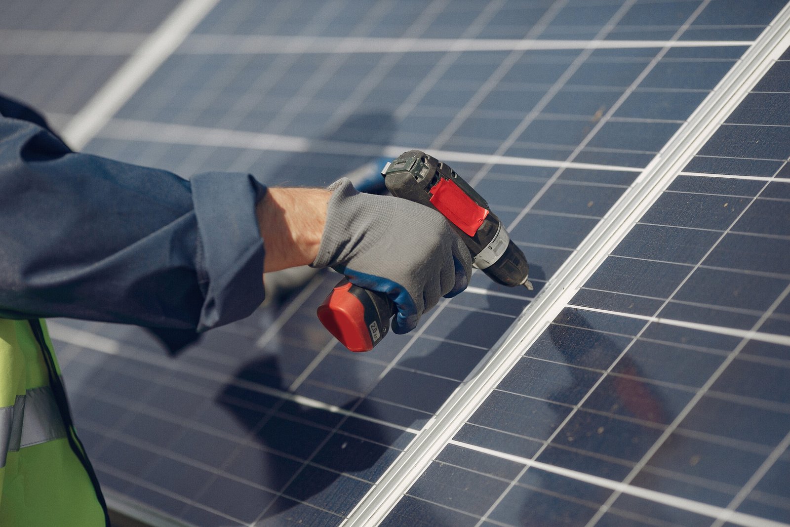 Engineer in a white helmet. Man near solar panel.